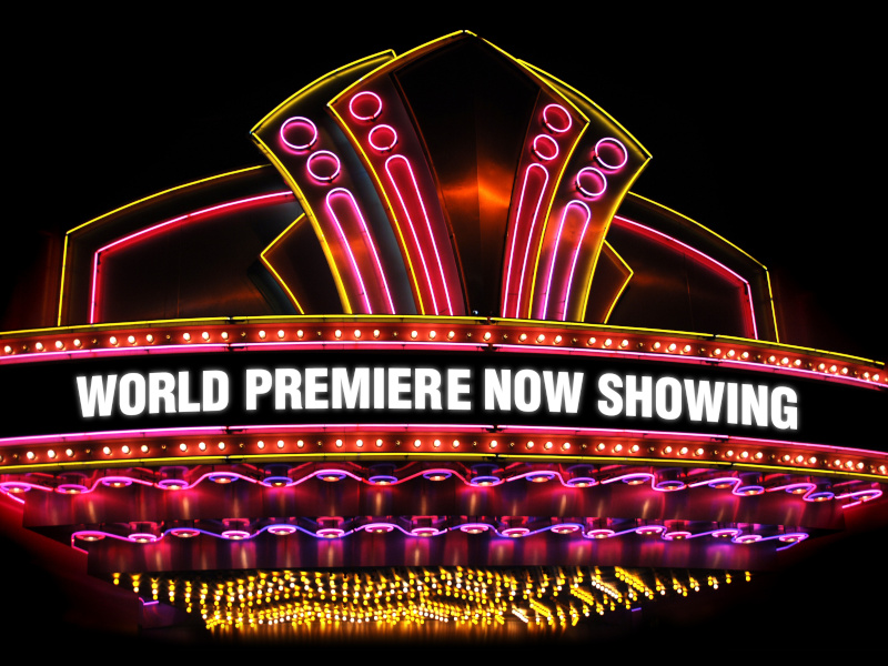 vibrant LED theater sign with pink and yellow LEDs, stating "World Premiere Now Showing"